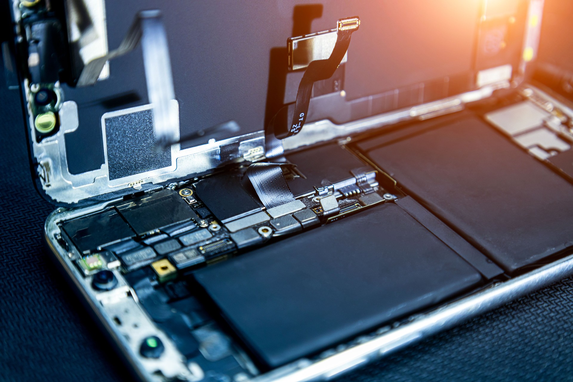 Disassembled smartphone on a dark background, phone repair and cleaning